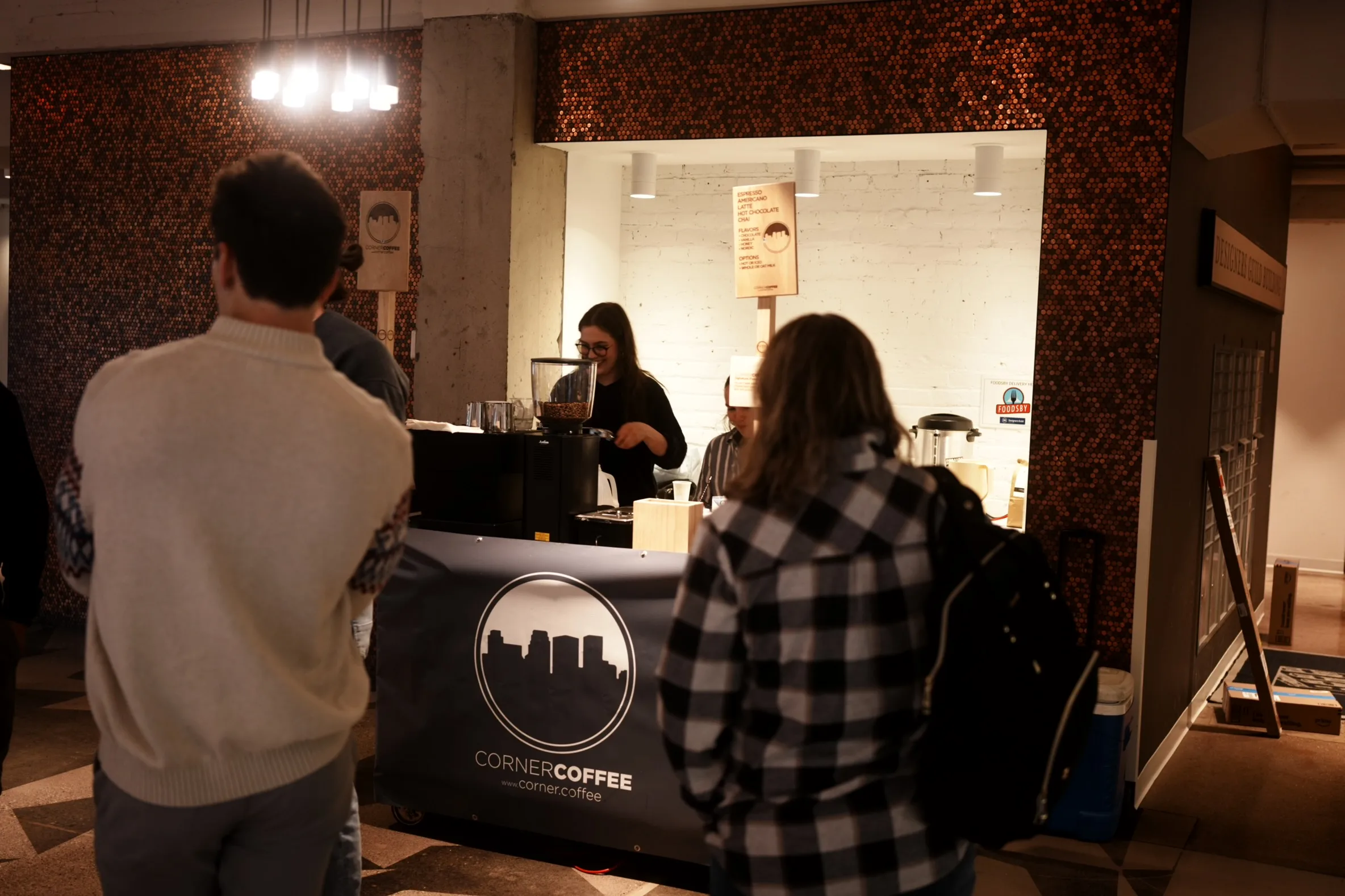 Guests gathered while a Corner Coffee barista serves from the mobile coffee cart