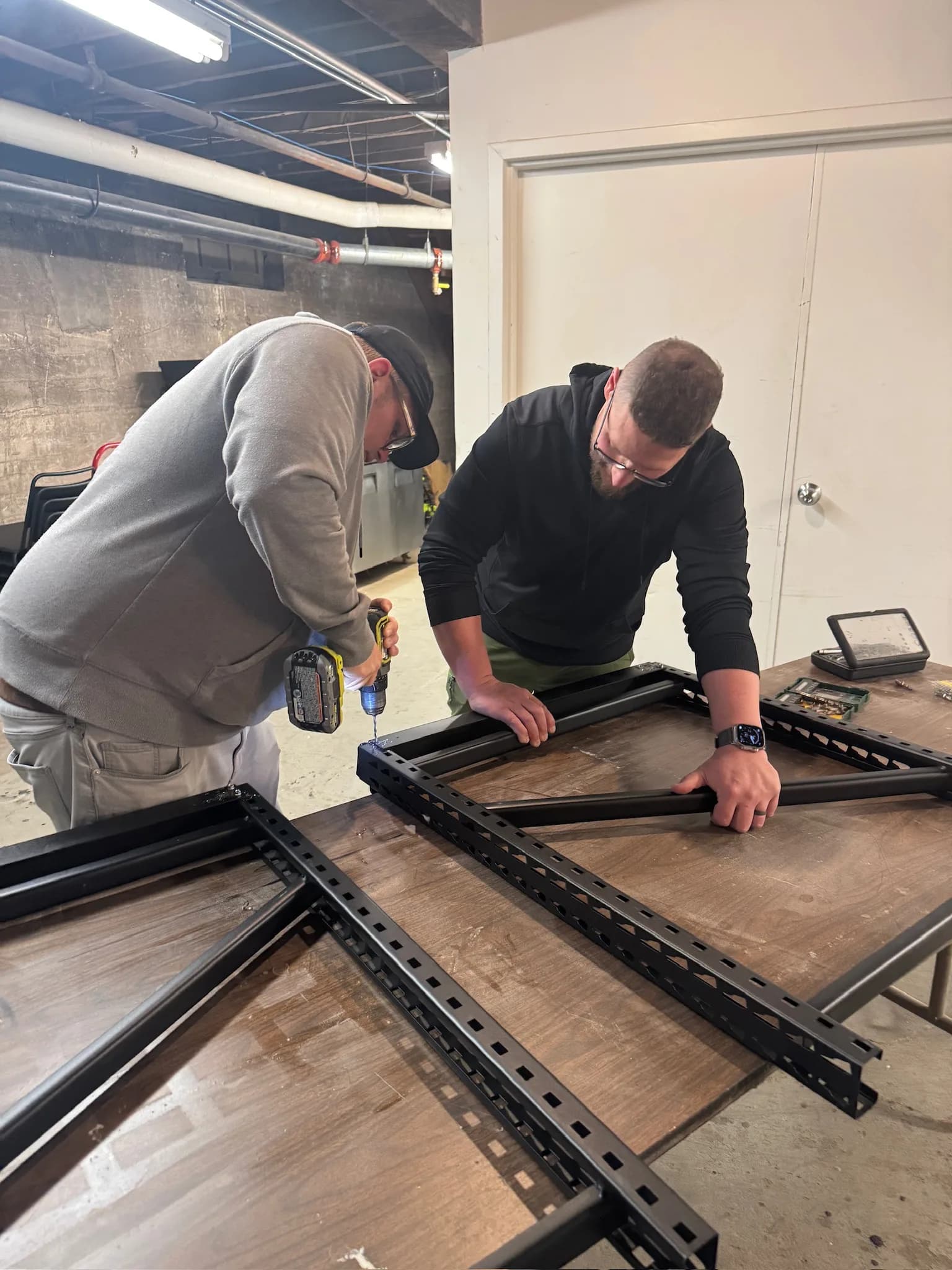 Corner Coffee team assembling the metal frame of a custom mobile coffee cart